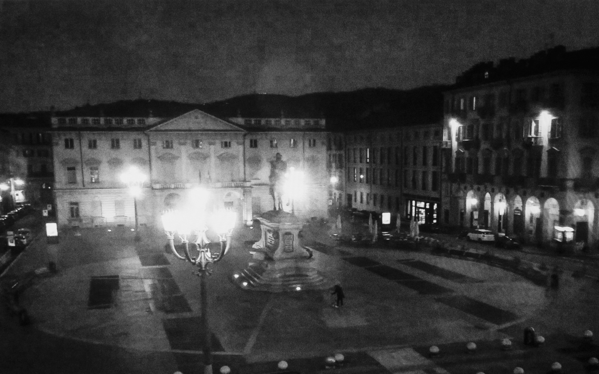 Torino, Giambattista Bodoni square - Men collecting poop of his dog after an evening stroll on Bodoni Square of Torino, Italy. March 26. 2020.